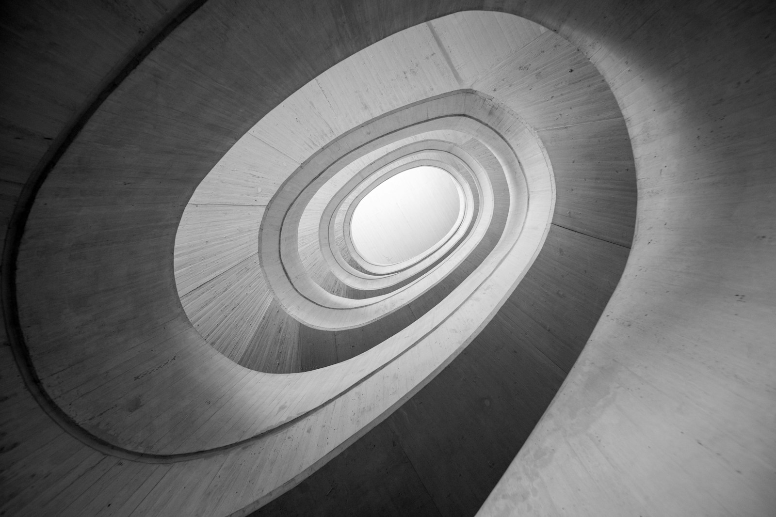 A black and white photo of a spiral staircase